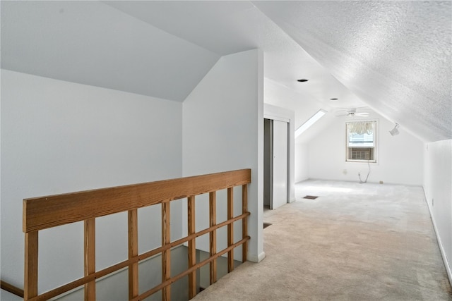 1039 27th St NE, Cedar Rapids, IA 52214 - additional living space with lofted ceiling, carpet flooring, ceiling fan, and a textured ceiling