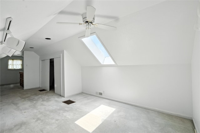 1039 27th St NE, Cedar Rapids, IA 52214 - additional living space featuring a skylight, lofted ceiling, carpet, and a ceiling fan