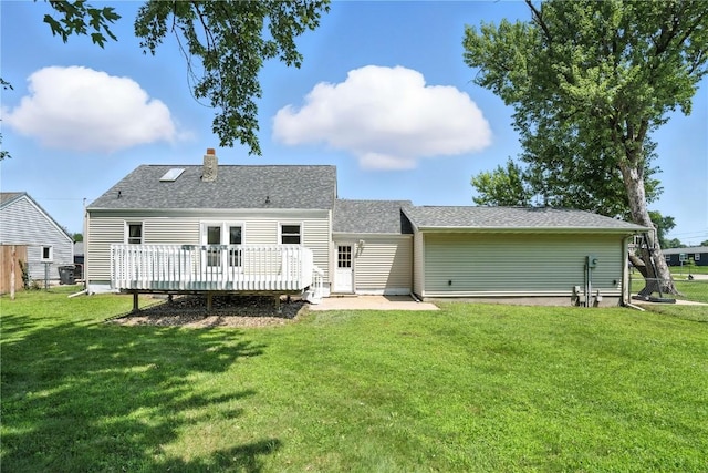 1039 27th St NE, Cedar Rapids, IA 52214 - back of house with a deck, a yard, a chimney, and roof with shingles
