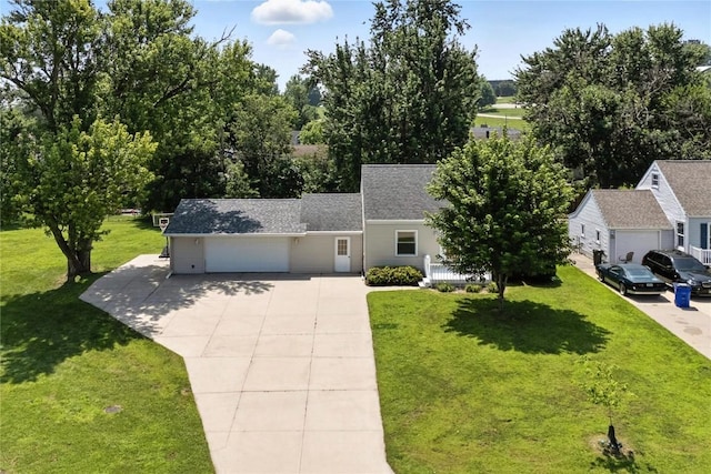 1039 27th St NE, Cedar Rapids, IA 52214 - view of front of house featuring concrete driveway, a garage, a front yard, and roof with shingles
