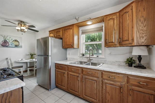 2226 Chandler SW, Cedar Rapids, IA 52404 - kitchen with brown cabinetry, light countertops, a ceiling fan, and freestanding refrigerator