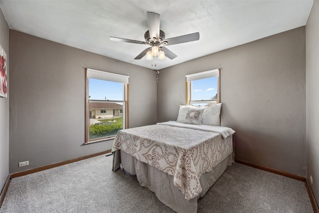 2226 Chandler SW, Cedar Rapids, IA 52404 - bedroom with multiple windows, light carpet, and a ceiling fan