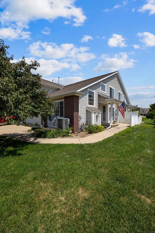 1167 74th St NE, Cedar Rapids, IA 52402 - view of front facade with a front yard and brick siding