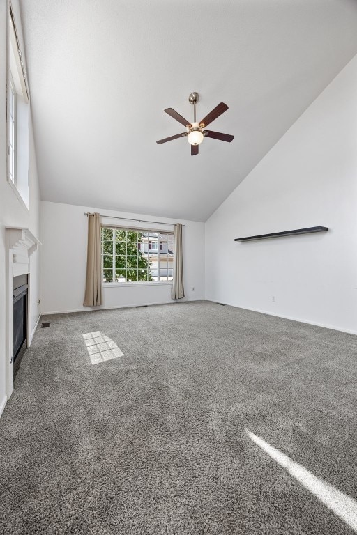 1167 74th St NE, Cedar Rapids, IA 52402 - unfurnished living room with vaulted ceiling, ceiling fan, a fireplace, and carpet