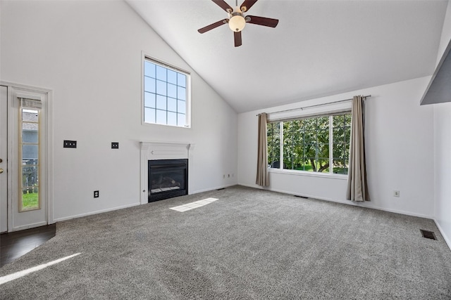 1167 74th St NE, Cedar Rapids, IA 52402 - unfurnished living room featuring high vaulted ceiling, a ceiling fan, healthy amount of natural light, carpet flooring, and a fireplace with flush hearth