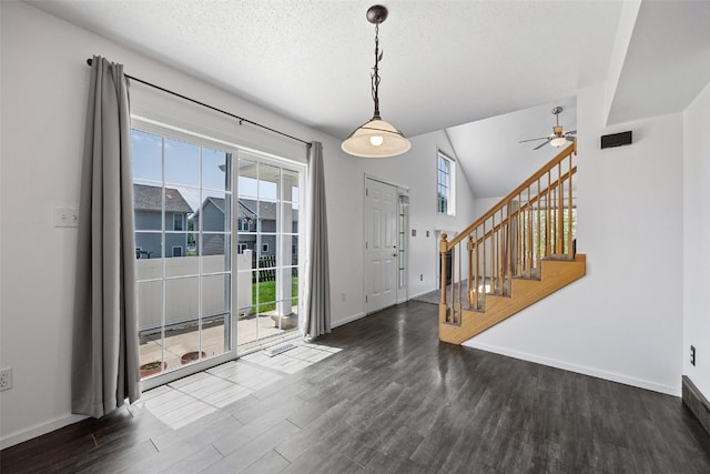 1167 74th St NE, Cedar Rapids, IA 52402 - entrance foyer featuring ceiling fan, wood finished floors, stairway, vaulted ceiling, and a textured ceiling