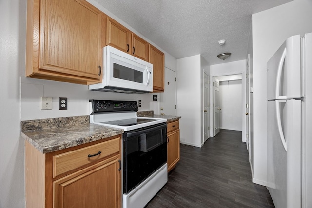 1167 74th St NE, Cedar Rapids, IA 52402 - kitchen with white appliances, dark wood-style floors, and a textured ceiling