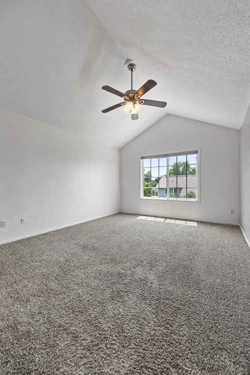 1167 74th St NE, Cedar Rapids, IA 52402 - carpeted empty room with vaulted ceiling, ceiling fan, and a textured ceiling