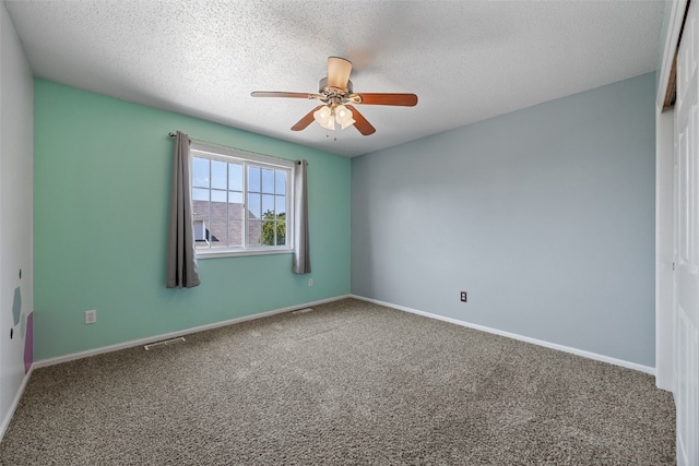 1167 74th St NE, Cedar Rapids, IA 52402 - unfurnished room with a ceiling fan, carpet floors, and a textured ceiling