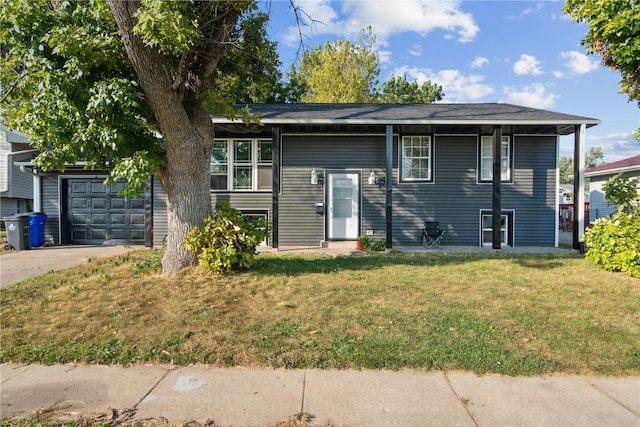 1638 47th St NE, Cedar Rapids, IA 52402 - view of front of house featuring concrete driveway, a front yard, and a garage