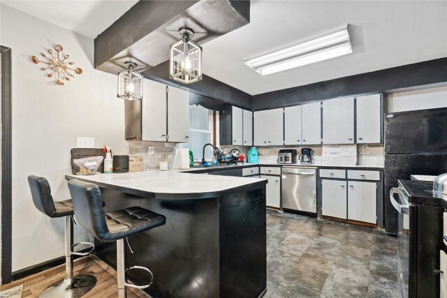 1638 47th St NE, Cedar Rapids, IA 52402 - kitchen featuring tasteful backsplash, a peninsula, stainless steel dishwasher, and electric stove