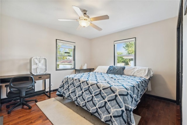 1638 47th St NE, Cedar Rapids, IA 52402 - bedroom with multiple windows, dark wood-type flooring, and a ceiling fan