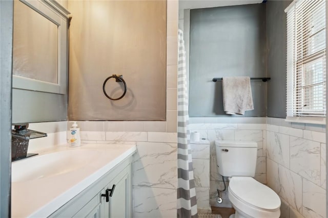 1638 47th St NE, Cedar Rapids, IA 52402 - bathroom with tile walls, vanity, a wainscoted wall, and a shower with curtain