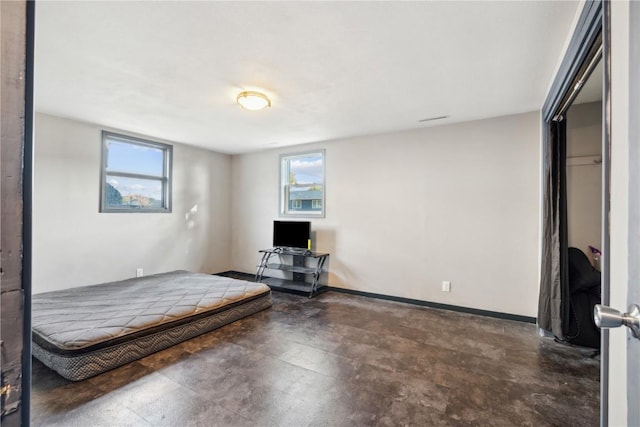 1638 47th St NE, Cedar Rapids, IA 52402 - bedroom featuring concrete floors and baseboards