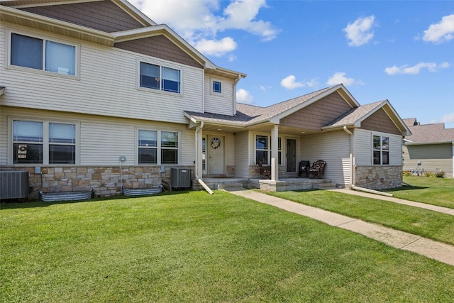 3221 English Cove Ln, Marion, IA 52302 - view of front of home featuring stone siding, a shingled roof, and a front lawn