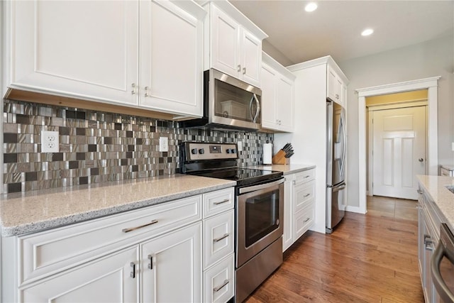 1627 Settlers Dr, Marion, IA 52302 - kitchen featuring stainless steel appliances, white cabinets, decorative backsplash, and recessed lighting