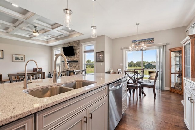 1627 Settlers Dr, Marion, IA 52302 - kitchen with dark wood-style flooring, stainless steel dishwasher, hanging light fixtures, light stone countertops, and beam ceiling