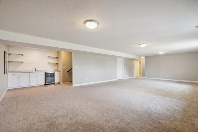 1627 Settlers Dr, Marion, IA 52302 - unfurnished living room featuring wet bar, light colored carpet, beverage cooler, a textured ceiling, and stairs