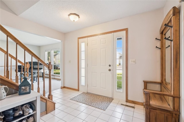 405 Stoney Creek Rd NW, Cedar Rapids, IA 52405 - foyer entrance featuring stairway, light tile patterned floors, and a textured ceiling