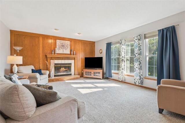 405 Stoney Creek Rd NW, Cedar Rapids, IA 52405 - carpeted living area with a tiled fireplace and wooden walls
