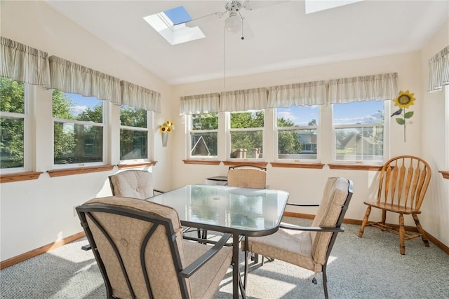 405 Stoney Creek Rd NW, Cedar Rapids, IA 52405 - dining area featuring a skylight, vaulted ceiling, a ceiling fan, and carpet