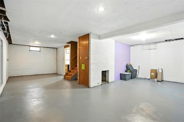 2153 Echo Hill Rd, Marion, IA 52302 - basement featuring stairs, concrete block wall, and a brick fireplace