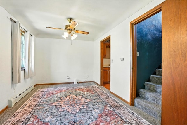 2153 Echo Hill Rd, Marion, IA 52302 - carpeted spare room featuring a baseboard heating unit, a ceiling fan, and stairs