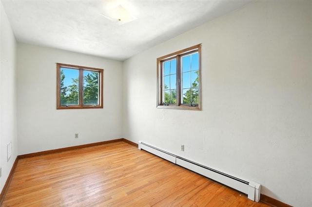 2153 Echo Hill Rd, Marion, IA 52302 - spare room featuring a baseboard radiator and light wood-style floors