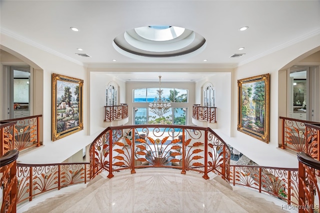 hallway with crown molding and a notable chandelier