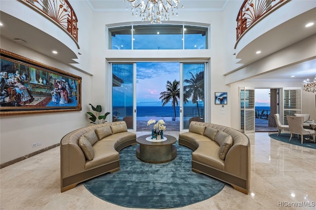 living room featuring crown molding, a water view, and a high ceiling