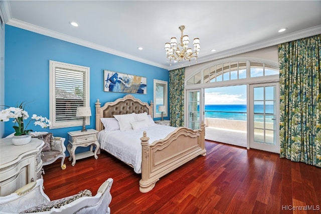 bedroom featuring dark wood-type flooring, crown molding, a notable chandelier, and a water view