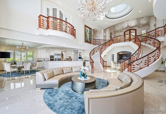 living room with a high ceiling and an inviting chandelier