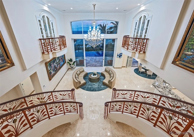 stairway with crown molding and a chandelier