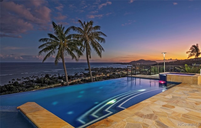 pool at dusk with a water view