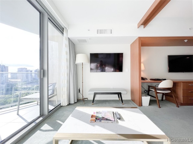 living room featuring built in desk, beam ceiling, and light colored carpet