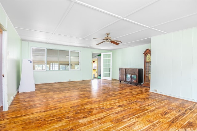 unfurnished living room featuring hardwood / wood-style flooring and ceiling fan