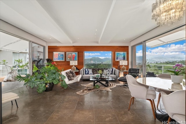 sunroom featuring a mountain view and beamed ceiling