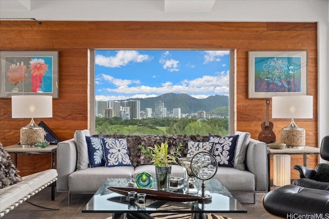 living room featuring wooden walls and a mountain view