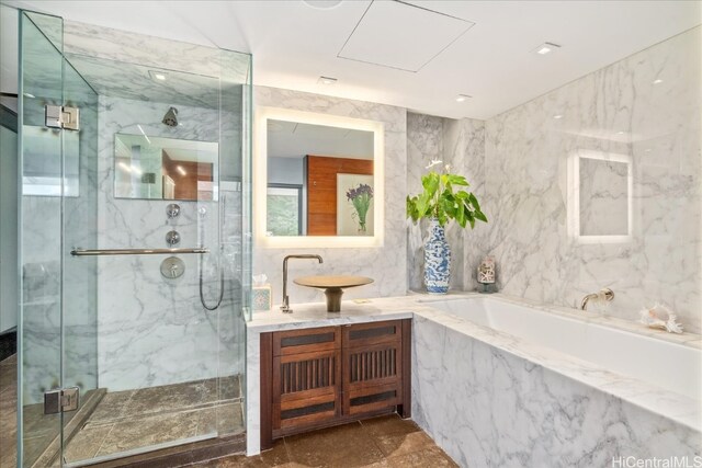 bathroom with vanity, tile walls, and separate shower and tub