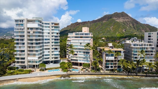 view of building exterior featuring a water and mountain view