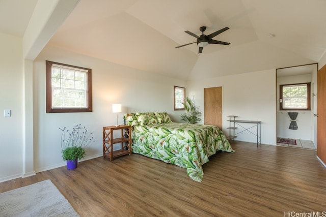 bedroom featuring ceiling fan, vaulted ceiling, multiple windows, and hardwood / wood-style floors