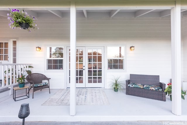 view of exterior entry featuring a patio and french doors