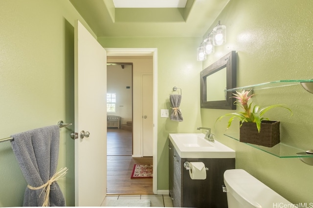 bathroom with vanity, hardwood / wood-style flooring, and toilet