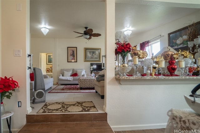 living room featuring ceiling fan and tile patterned flooring