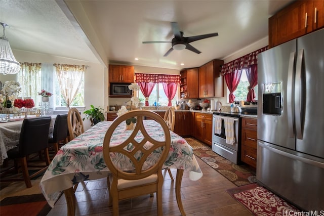 kitchen featuring dark wood-type flooring, appliances with stainless steel finishes, and plenty of natural light