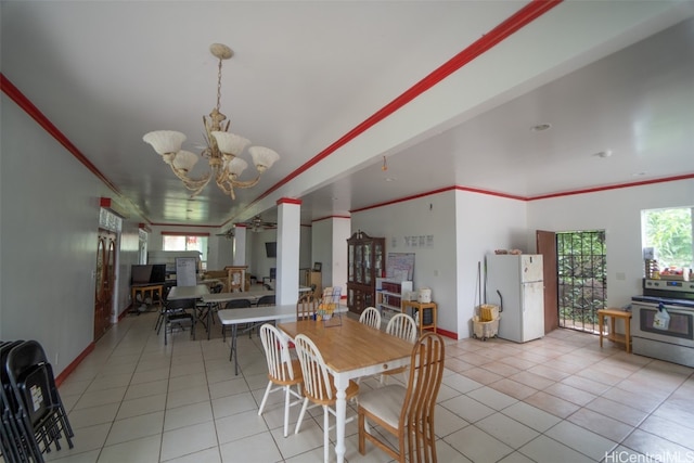 dining room featuring ornamental molding, light tile patterned floors, and a chandelier