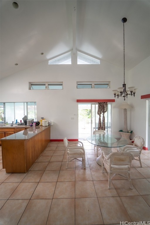 tiled dining area featuring a notable chandelier, beam ceiling, high vaulted ceiling, and plenty of natural light