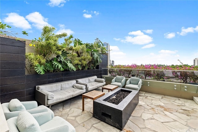 view of patio / terrace featuring an outdoor living space with a fire pit