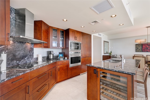 kitchen with wall chimney range hood, beverage cooler, dark stone counters, black electric cooktop, and sink