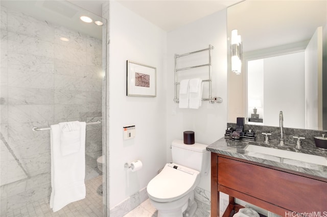 bathroom with toilet, vanity, and tiled shower